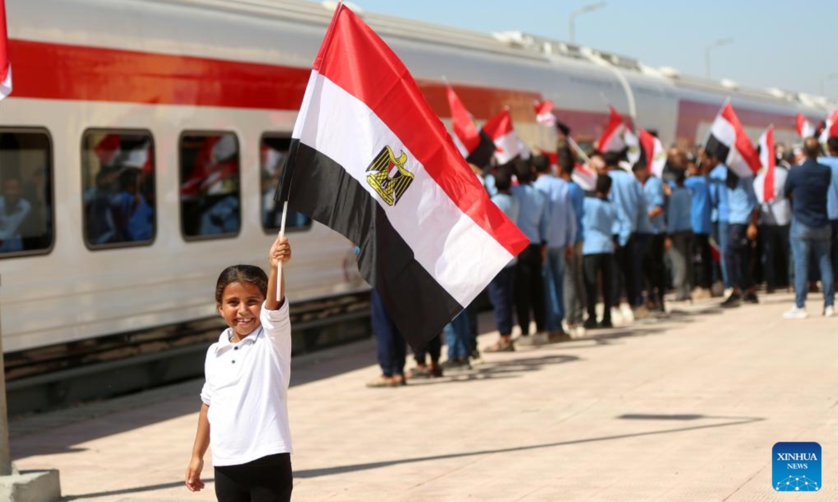 People celebrate the trial operation of a railway in North Sinai, Egypt, on Oct. 7, 2024. A 100-kilometer railway in North Sinai began trial operations on Monday, restoring train service to the region for the first time in more than half a century. (Photo: Xinhua)