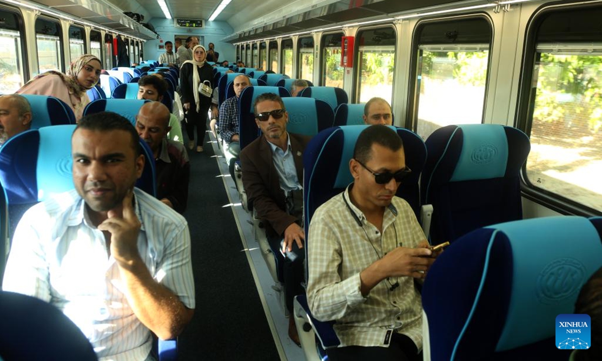 People take a train during the trial operation of a railway in North Sinai, Egypt, on Oct. 7, 2024. A 100-kilometer railway in North Sinai began trial operations on Monday, restoring train service to the region for the first time in more than half a century. (Photo: Xinhua)