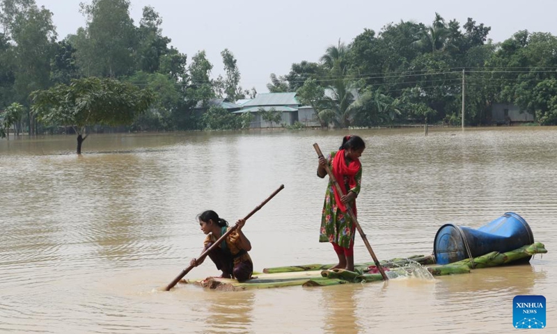 People take a raft in the floodwater in Mymensingh, Bangladesh, Oct. 7, 2024. Days of devastating flash floods, triggered by heavy rains and upstream torrents, have stranded hundreds of thousands of people in Bangladesh's northern Mymensingh region, with thousands of homes still under water. (Photo: Xinhua)