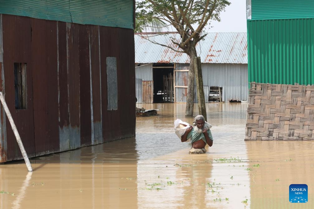 An old man wades through floodwater in Mymensingh, Bangladesh, Oct. 7, 2024. Days of devastating flash floods, triggered by heavy rains and upstream torrents, have stranded hundreds of thousands of people in Bangladesh's northern Mymensingh region, with thousands of homes still under water. (Photo: Xinhua)