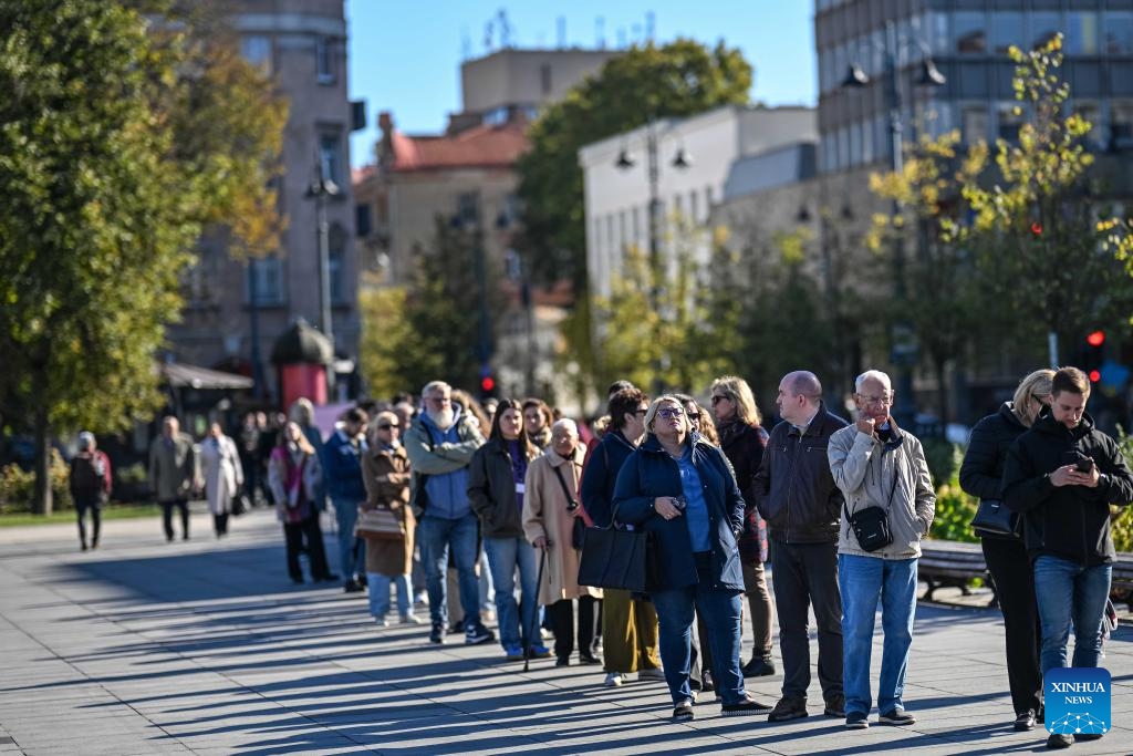 Voters wait for their turns to vote at a polling station for the parliament elections in Vilnius, Lithuania, Oct. 8, 2024. Early voting for Lithuania's parliamentary elections began on Tuesday and will continue for three days. (Photo: Xinhua)