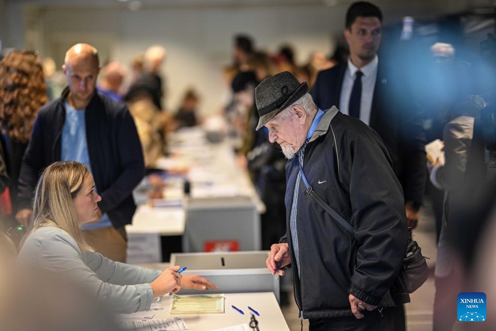 A voter prepares for voting at a polling station for the parliamentary elections in Vilnius, Lithuania, Oct. 8, 2024. Early voting for Lithuania's parliamentary elections began on Tuesday and will continue for three days. (Photo: Xinhua)