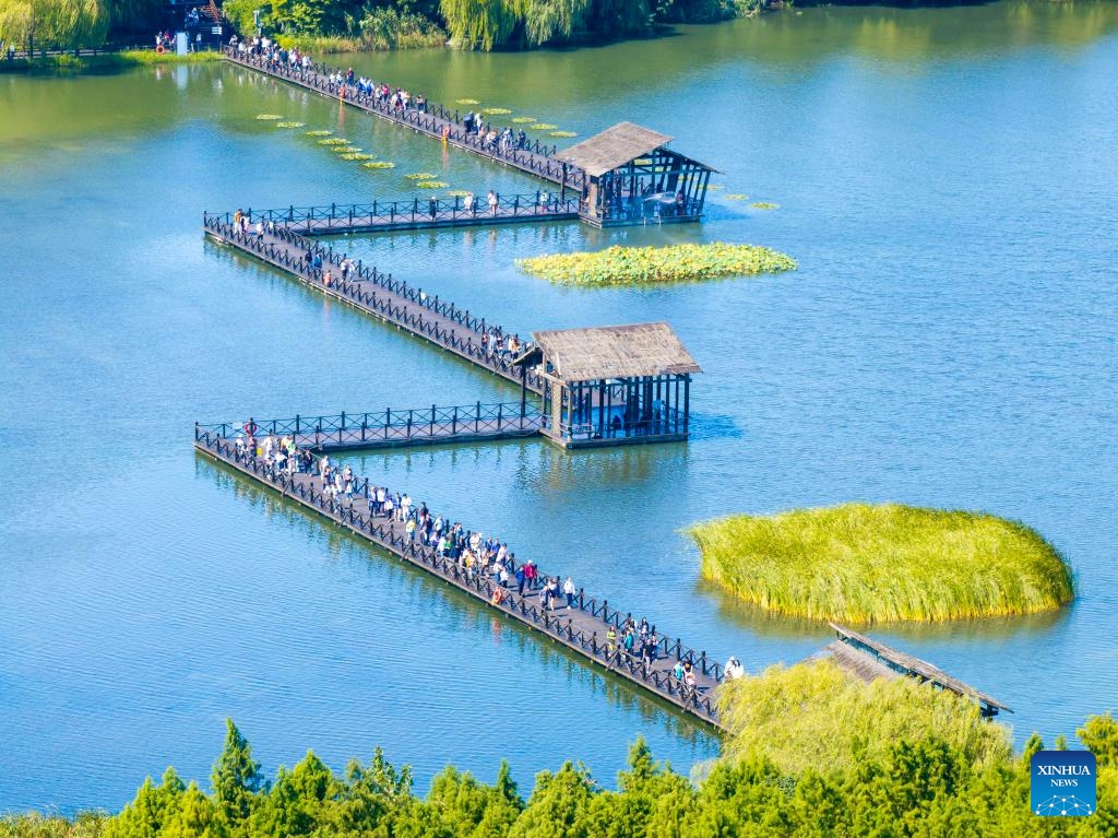 In this aerial drone photo, tourists visit Qinhu National Wetland Park in Jiangyan District of Taizhou, east China's Jiangsu Province, Oct. 2, 2024. China recorded 765 million domestic tourist trips during the 7-day National Day holiday that ended Monday, representing a year-on-year increase of 5.9 percent on a comparable basis, according to data from the Ministry of Culture and Tourism. (Photo: Xinhua)