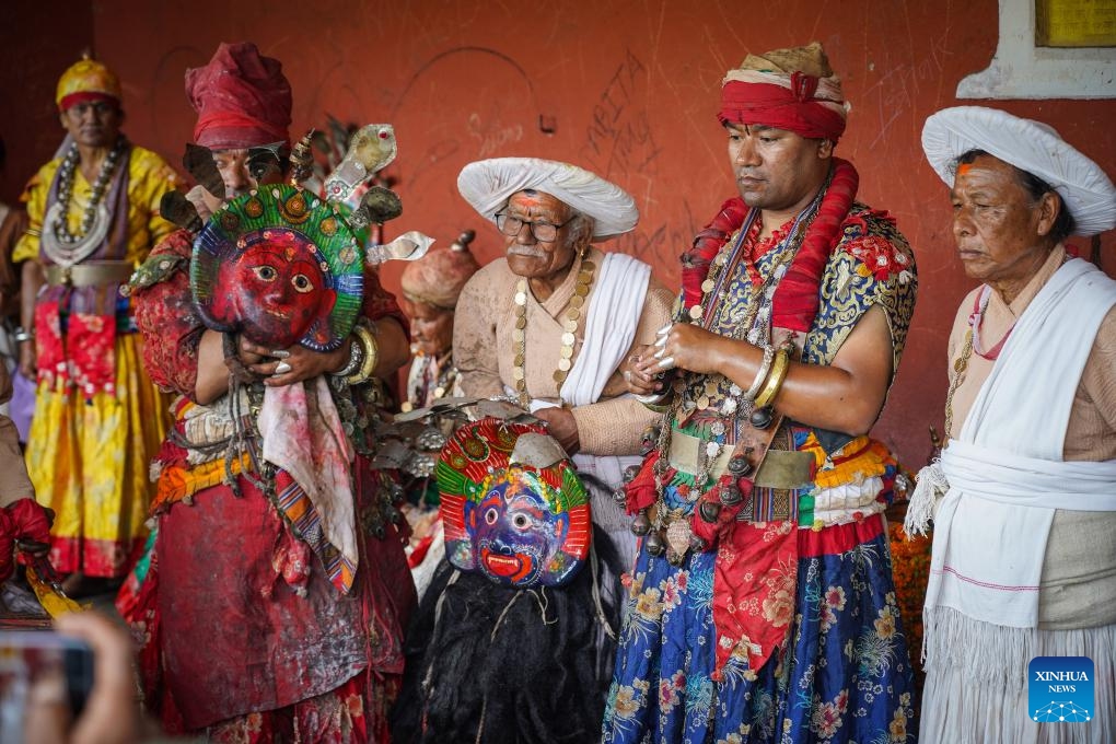 Performers get ready to perform a mask dance during the celebration of the festival of Rudrayani, widely known as Sikali Jatra, in Khokana village of Lalitpur, Nepal, Oct. 8, 2024. (Photo: Xinhua)