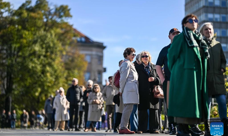 Voters wait for their turns to vote at a polling station for the parliament elections in Vilnius, Lithuania, Oct. 8, 2024. Early voting for Lithuania's parliamentary elections began on Tuesday and will continue for three days. (Photo: Xinhua)