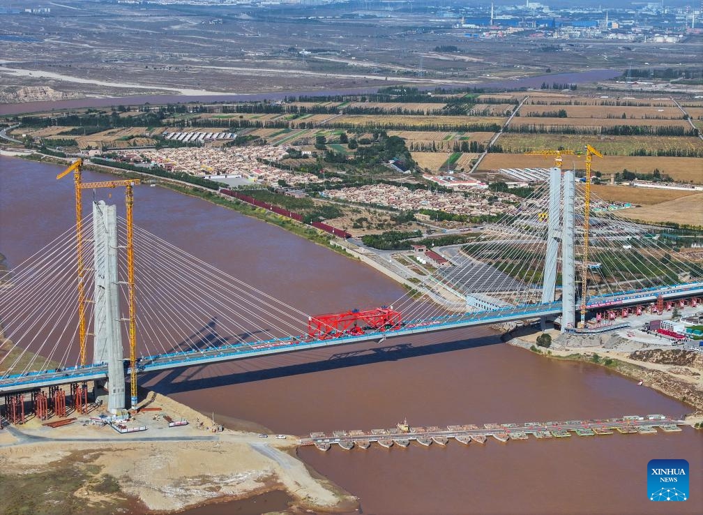 An aerial drone photo shows the construction site of the Wuhai Yellow River grand bridge in north China's Inner Mongolia Autonomous Region, Oct. 9, 2024. This grand bridge, part of the Baotou-Yinchuan high-speed railway, was joined together on Wednesday. With a designed speed of 250 km per hour, the Baotou-Yinchuan high-speed railway is a crucial link along the Beijing-Lanzhou horizontal trunk line in the nation-wide high-speed railway network. (Photo: Xinhua)