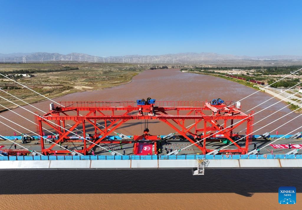 An aerial drone photo shows the construction site of the Wuhai Yellow River grand bridge in north China's Inner Mongolia Autonomous Region, Oct. 9, 2024. This grand bridge, part of the Baotou-Yinchuan high-speed railway, was joined together on Wednesday. With a designed speed of 250 km per hour, the Baotou-Yinchuan high-speed railway is a crucial link along the Beijing-Lanzhou horizontal trunk line in the nation-wide high-speed railway network. (Photo: Xinhua)