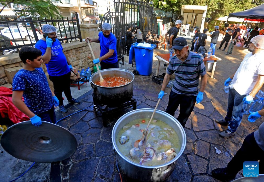 Volunteers prepare food for displaced people in Beirut, Lebanon, Oct. 9, 2024. (Photo: Xinhua)