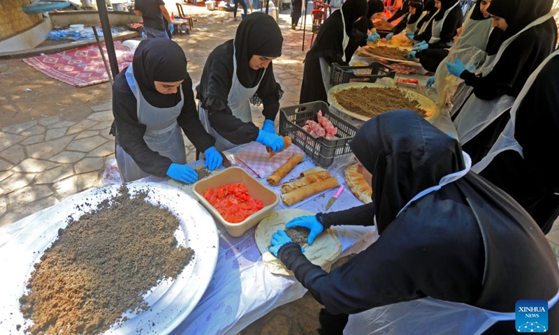 Volunteers prepare food for displaced people in Beirut, Lebanon, Oct. 9, 2024. (Photo: Xinhua)