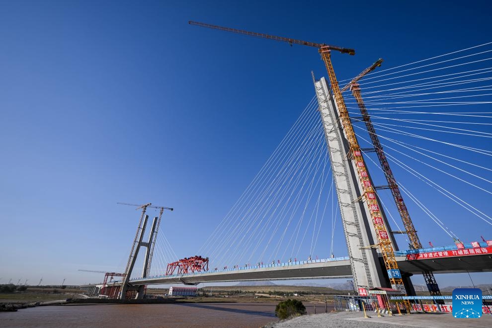 This photo shows the construction site of the Wuhai Yellow River grand bridge in north China's Inner Mongolia Autonomous Region, Oct. 9, 2024. This grand bridge, part of the Baotou-Yinchuan high-speed railway, was joined together on Wednesday. With a designed speed of 250 km per hour, the Baotou-Yinchuan high-speed railway is a crucial link along the Beijing-Lanzhou horizontal trunk line in the nation-wide high-speed railway network. (Photo: Xinhua)