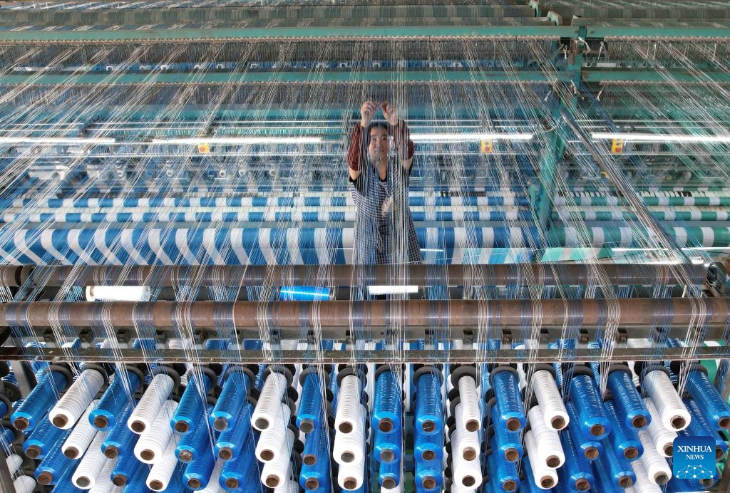 A man works at a workshop of a net-manufacturing company in Huimin County, east China's Shandong Province, Oct. 8, 2024. Huimin County boasts a three-century history in rope and net production, and is now home to hundreds of enterprises making such products. The county holds a lion's share in the national market for ropes and nets, which are widely used in construction, sports and other sectors. (Photo: Xinhua)