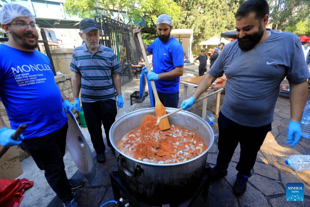 Volunteers prepare food for displaced people in Beirut, Lebanon, Oct. 9, 2024. (Photo: Xinhua)