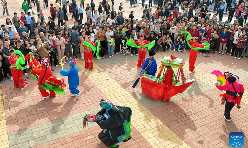 An aerial drone photo taken on Oct. 10, 2024 shows folk artists performing at a square in Baofeng County, central China's Henan Province. A series of activities to promote Baofeng's intangible cultural heritages were held here on Thursday (Photo: Xinhua)