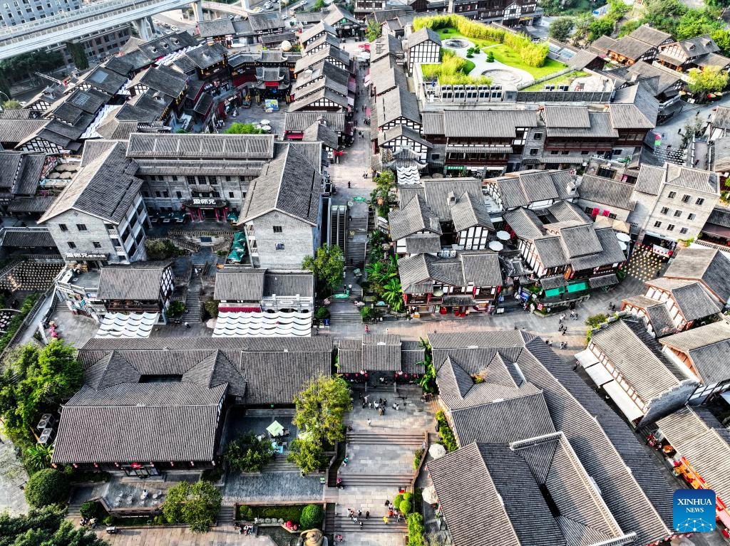 An aerial drone photo taken on Oct. 9, 2024 shows a view of the Ciqikou ancient town in southwest China's Chongqing Municipality. Located by the Jialing River in Chongqing, the ancient town of Ciqikou was first built in the Northern Song Dynasty (960-1127). In recent years, local authorities have advanced the integration of cultural and tourism development and the urban renewal, while preserving the authentic charm of the ancient town. (Photo: Xinhua)