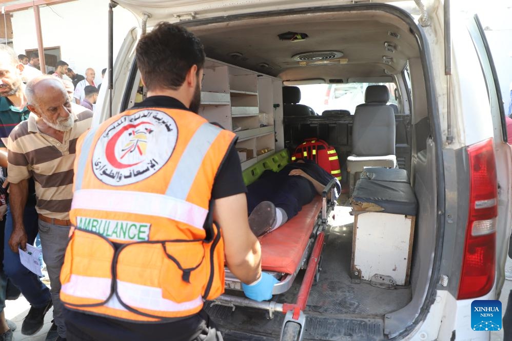 Medics evacuate an injured man from Al-Rimal clinic building after an Israeli bombardment in Gaza City, on Oct. 10, 2024. (Photo: Xinhua)