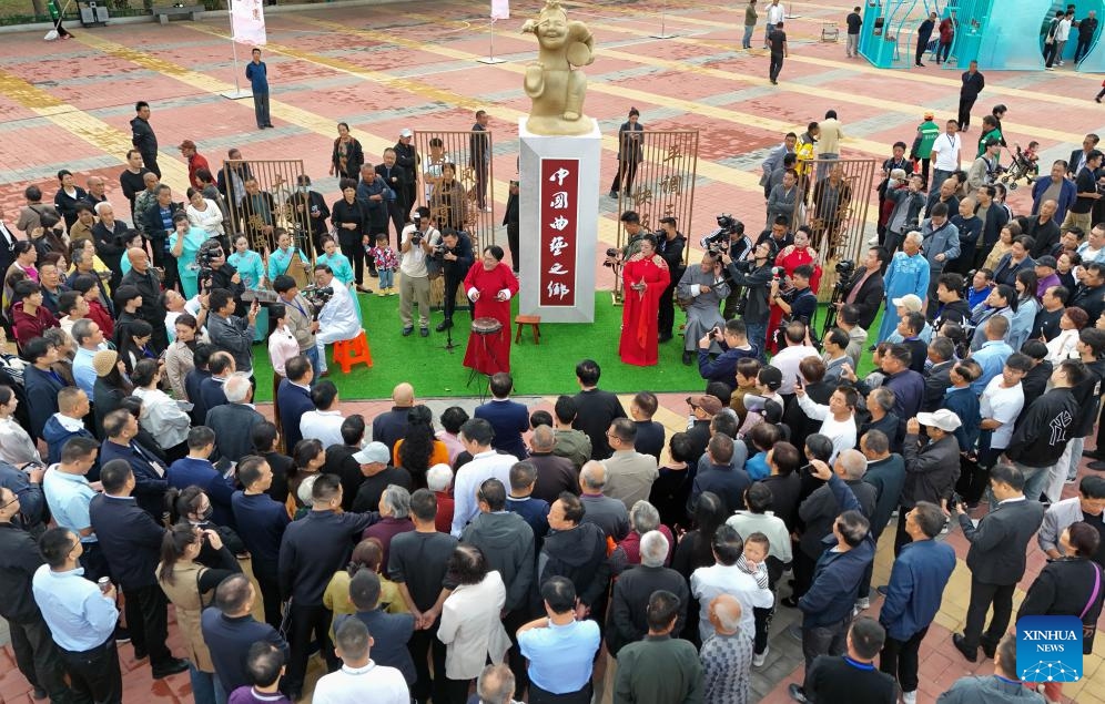 An aerial drone photo taken on Oct. 10, 2024 shows people watching folk art performances at a square in Baofeng County, central China's Henan Province. A series of activities to promote Baofeng's intangible cultural heritages were held here on Thursday. (Photo: Xinhua)