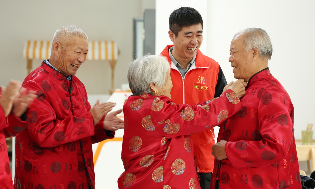 Elder people in Linyi, East China's Shandong Province, try new clothes, which are their gift for Chongyang Festival on October 10, 2024. The annual festival to show respect and care for the elderly throughout China falls on October 11 this year. Photo: VCG