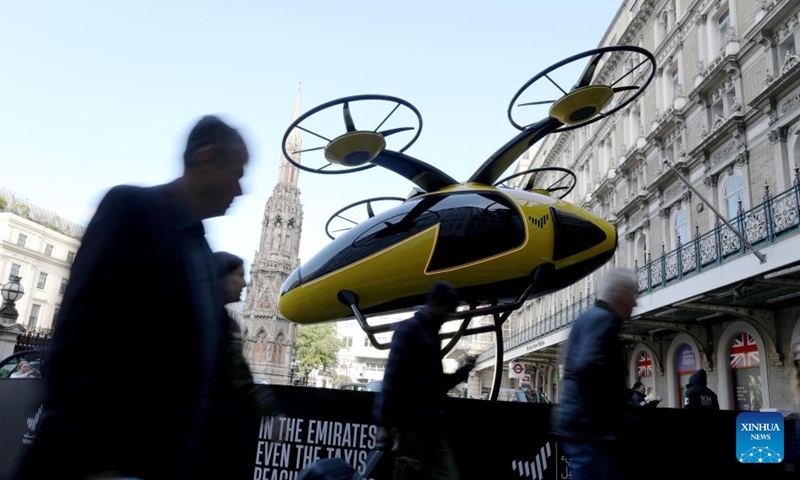 People pass a prototype of a flying taxi on display, which is currently in development in the United Arab Emirates (UAE), in the taxi rank outside Charing Cross railway station in London, Britain, Oct. 11, 2024. (Photo: Xinhua)