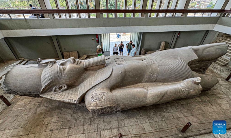 Tourists look at the statue of ancient Egyptian King Ramses II lying on its back at the Mit Rahina Museum in Giza, Egypt, on Oct. 11, 2024. (Photo: Xinhua)