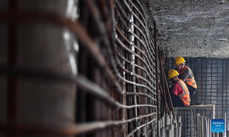 Workers work at the construction site of the Sanya River estuary passage project in Sanya, south China's Hainan Province, Oct. 12, 2024. The Sanya River estuary passage project undertaken by China Railway 20th Bureau Group is making steady progress. As the first underwater tunnel in Sanya, the project will further optimize the urban spatial layout and facilitate the development of the Hainan Free Trade Port. (Photo: Xinhua)