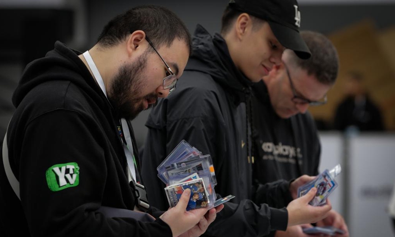 People look at the trading cards during the Vancity Card Show at the Vancouver Convention Center in Vancouver, Canada, Oct. 11, 2024. The three-day event for trading card enthusiasts, which kicked off on Friday, attracted collectors and fans of all ages. (Photo: Xinhua)