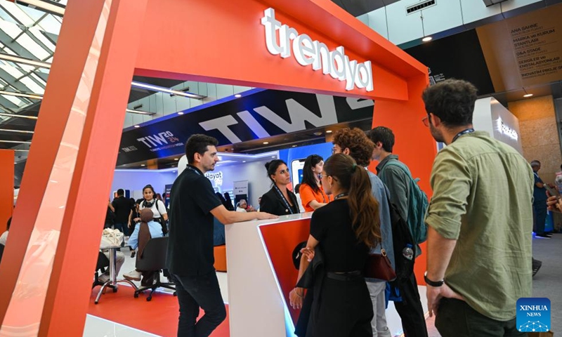 Staff members of a Turkish e-commerce company talk with visitors during Türkiye Innovation Week 2024 in Istanbul, Türkiye, Oct. 11, 2024. The event was held at the Halic Congress Center in Istanbul from Oct. 10 to 12. (Photo: Xinhua)