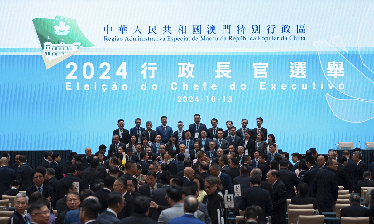 Chief Executive Election Committee members pose for photos ahead of the chief executive election in Macao Special Administrative Region (SAR) on October 13, 2024. Sam Hou Fai was elected by an overwhelming majority as the sixth-term chief executive designate. Photo: VCG