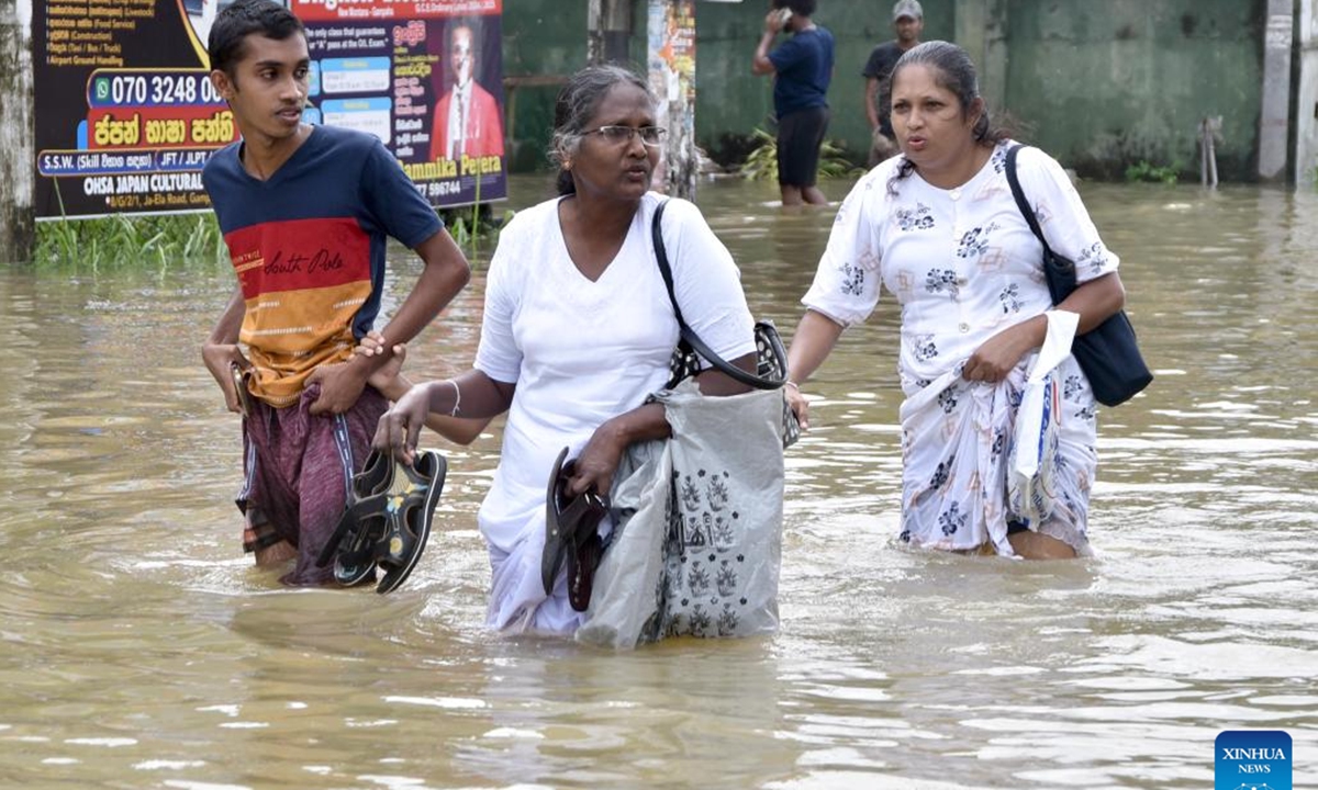 People wade through floodwater in a street in Gampaha, Sri Lanka, on Oct. 12, 2024. Sri Lankan president Anura Kumara Dissanayake has instructed officials to provide immediate relief to people affected by recent adverse weather conditions across the country, the President's Media Division (PMD) said on Saturday. (Photo: Xinhua)