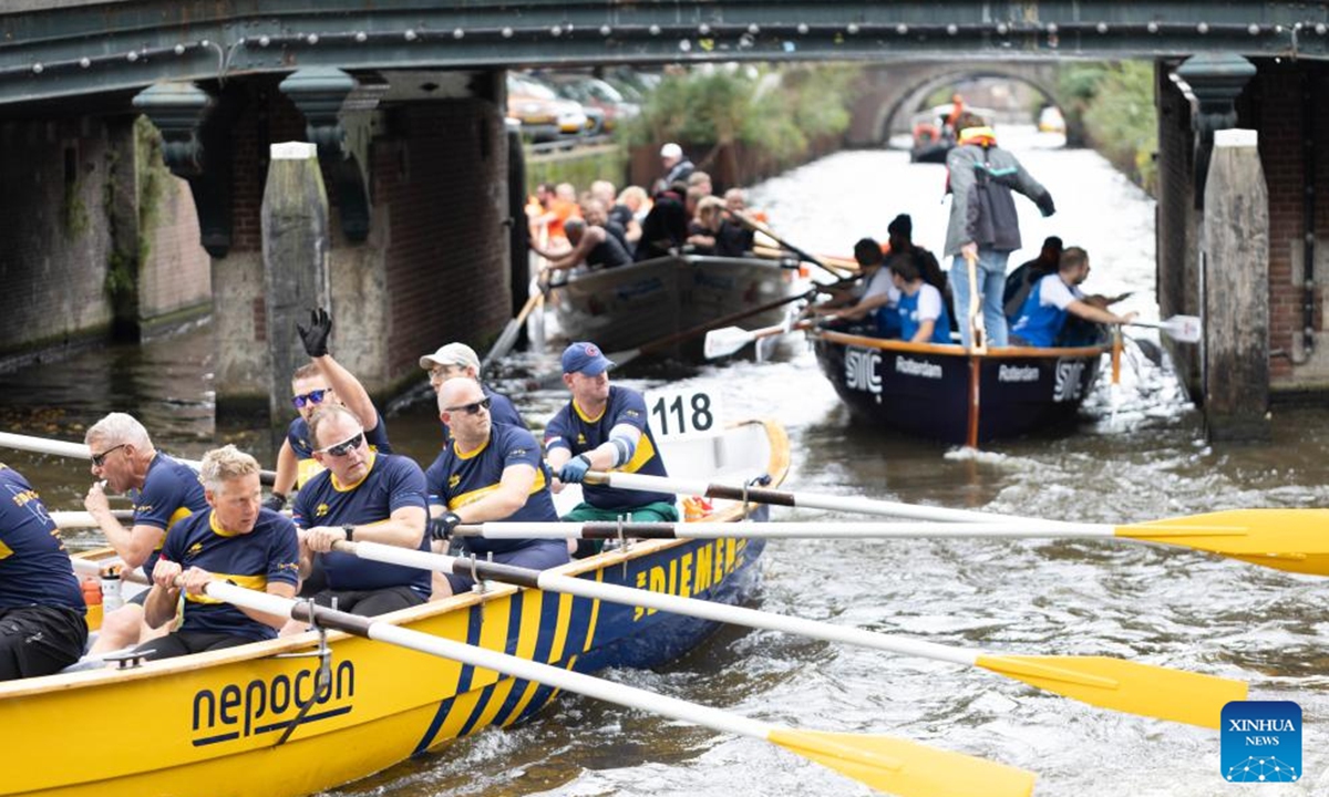 People take part in the Amsterdam Canal Race (Grachtenrace) in Amsterdam, the Netherlands, Oct. 12, 2024. As one of the city's most iconic sporting events, this year's race featured over 130 teams competing along a nearly 25km route through the historic canals. (Photo: Xinhua)