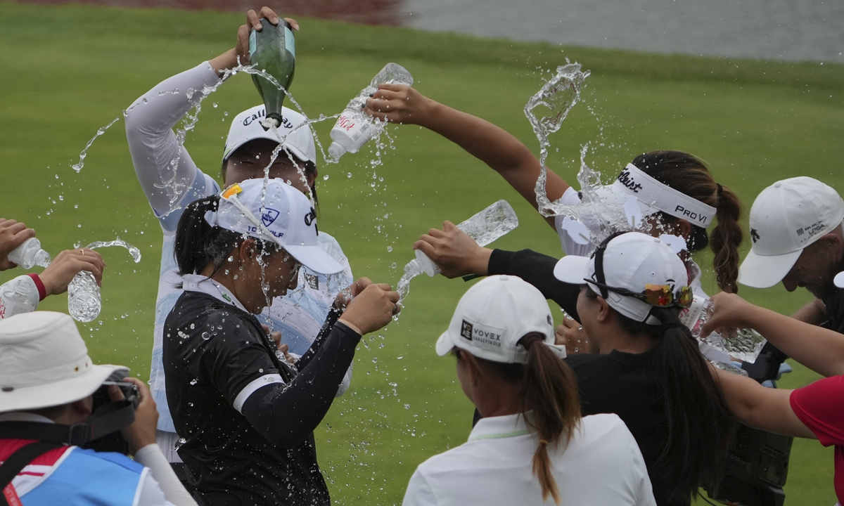 Fellow golfers sprinkle water on winner Yin Ruoning of China after the final round of the 2024 Buick LPGA Shanghai at the Shanghai Qizhong Garden Golf Club on October 13, 2024. Yin finished with a remarkable four-round total of 263 strokes, 25 under par, becoming the first local player to win the title in the tournament's history. Photo: VCG