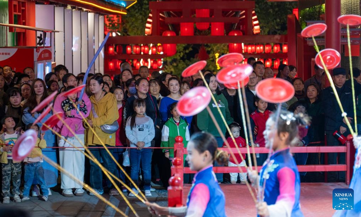 People watch a performance at a tourist attraction in Zhuxi County of Shiyan City, central China's Hubei Province, Oct. 12, 2024. (Photo: Xinhua)