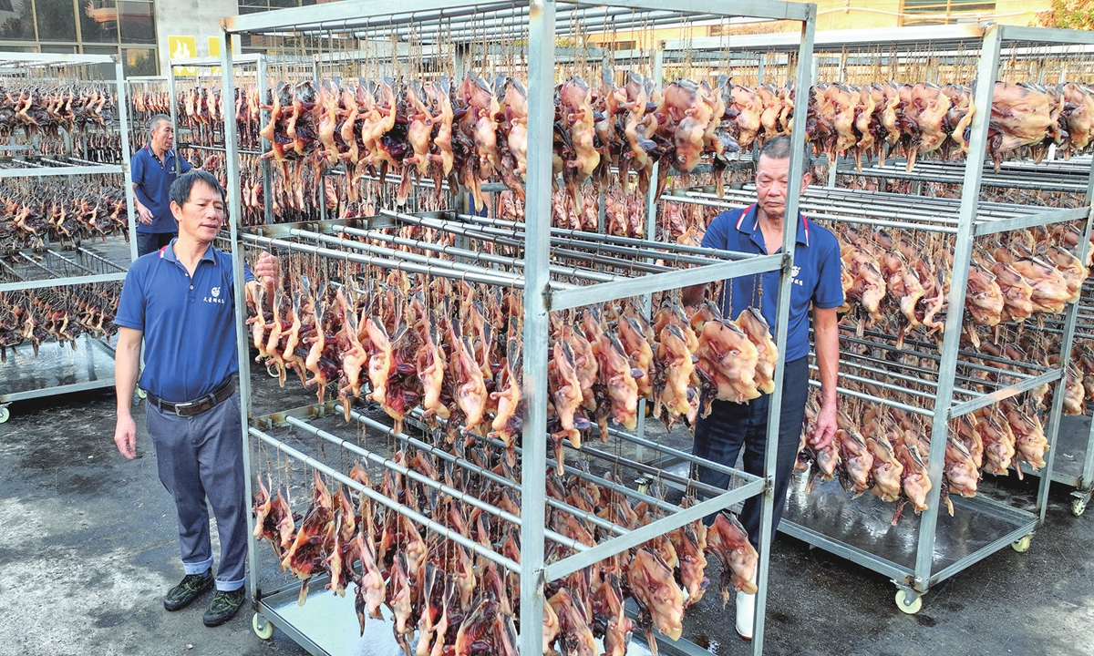 Workers dry ducks in a food company in Suichuan county, East China's Jiangxi Province on October 13, 2024. The county's salted duck products are exported to Southeast Asia and the EU, with an annual processing capacity of 10 million ducks and an output value of nearly 500 million yuan ($70.76 million). Photo: VCG