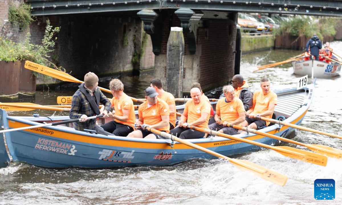 People take part in the Amsterdam Canal Race (Grachtenrace) in Amsterdam, the Netherlands, Oct. 12, 2024. As one of the city's most iconic sporting events, this year's race featured over 130 teams competing along a nearly 25km route through the historic canals. (Photo: Xinhua)