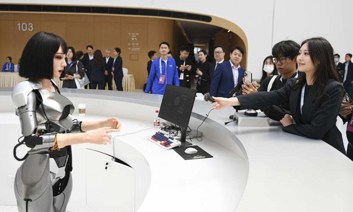 Journalists interact with a bionic humanoid robot at the Zhongguancun International Innovation Center, venue for the 2024 Zhongguancun Forum (ZGC Forum), in Beijing, capital of China, April 24, 2024. (Photo: Xinhua)