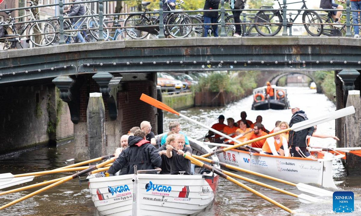 People take part in the Amsterdam Canal Race (Grachtenrace) in Amsterdam, the Netherlands, Oct. 12, 2024. As one of the city's most iconic sporting events, this year's race featured over 130 teams competing along a nearly 25km route through the historic canals. (Photo: Xinhua)