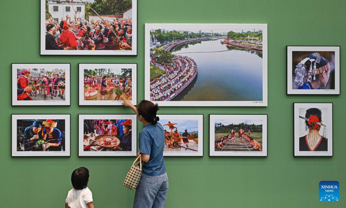 People visit the Guarding Rainforest Homeland exhibition in Haikou, south China's Hainan Province, Oct. 13, 2024. The Guarding Rainforest Homeland exhibition has been held by the management office of the National Park of Hainan Tropical Rainforest in Haikou. Featuring animal specimens, photographs and videos, the exhibition showcases the beauty of rainforest and introduces the construction process of the National Park of Hainan Tropical Rainforest. (Photo: Xinhua)