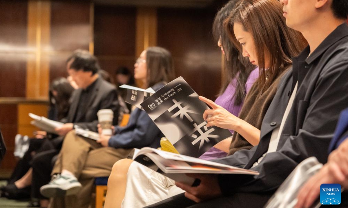 An attendee reads the program book of the 7th China Now Music Festival at Carnegie Hall in New York, the United States, Oct. 12, 2024. (Photo: Xinhua)