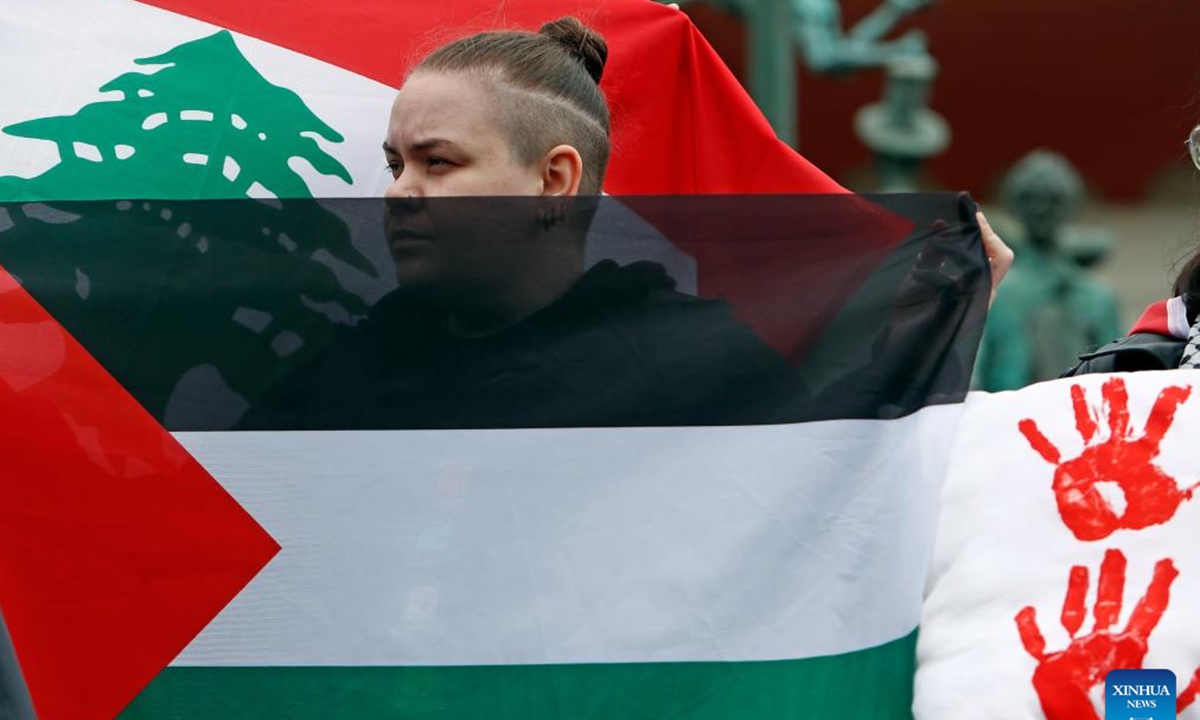 A woman attends a rally in support of Palestine and Lebanon in Bucharest, Romania, Oct. 12, 2024. (Photo: Xinhua)