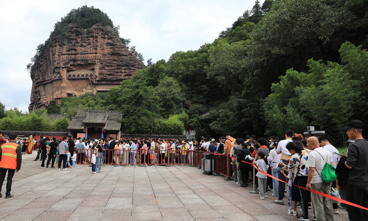 Visitors wait in line to explore the Maijishan Grottoes in Tianshui, Northwest China's Gansu Province. Photo: VCG