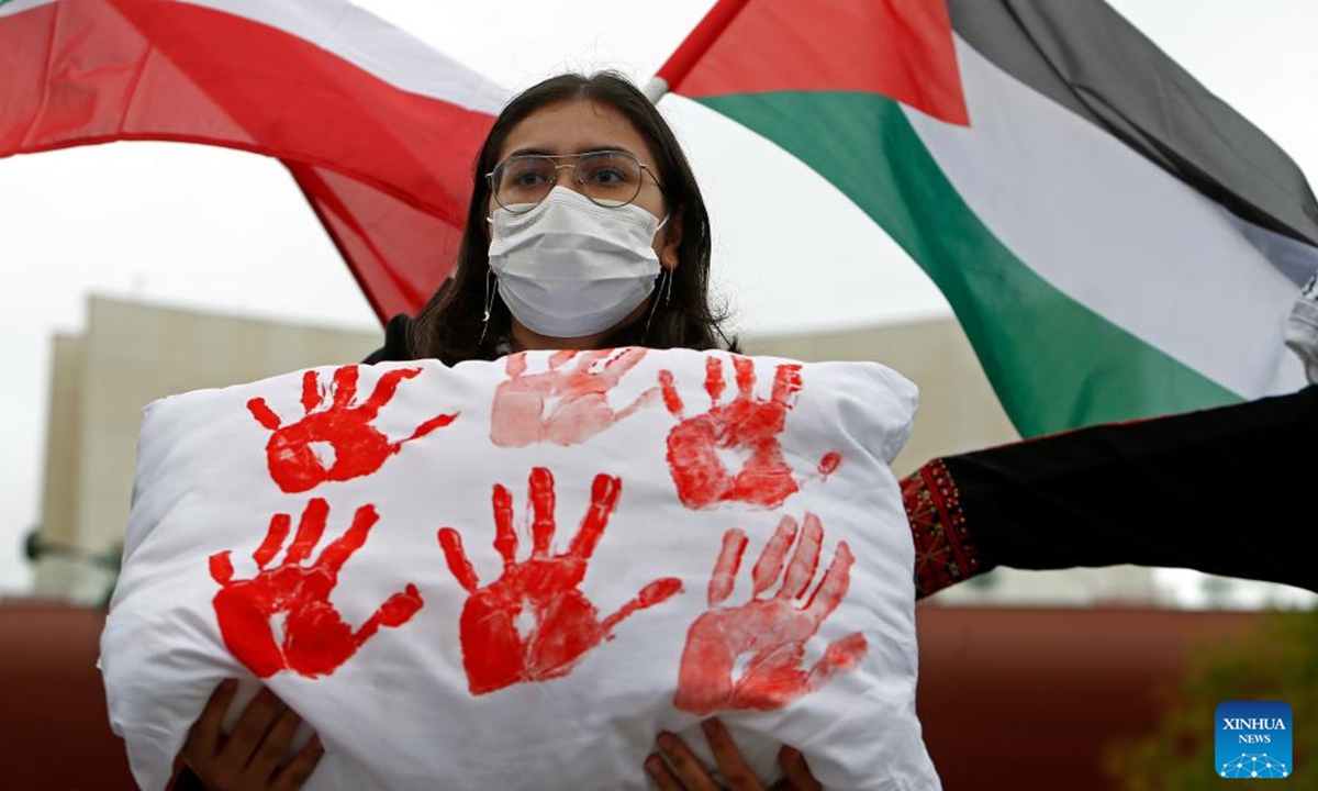 A woman attends a rally in support of Palestine and Lebanon in Bucharest, Romania, Oct. 12, 2024. (Photo: Xinhua)