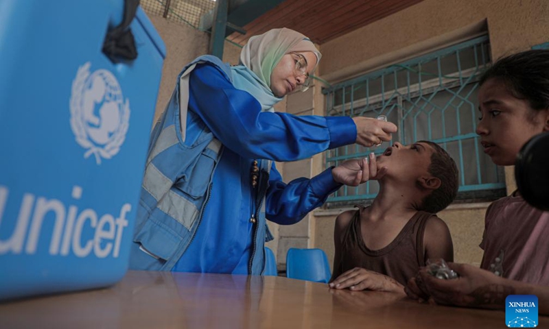 A child receives a dose of the polio vaccine at a UN-run clinic in Deir al-Balah city, central Gaza Strip, on Oct. 14, 2024. Gaza-based health authorities said on Saturday that the second round of the polio vaccination campaign in the central Gaza Strip is scheduled to start on Monday for three or four days. (Photo: Xinhua)