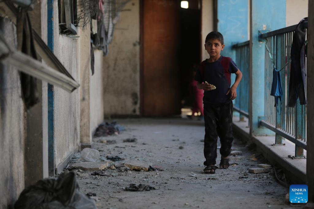 A Palestinian child is seen at a school housing displaced persons in Nuseirat camp in the central Gaza Strip after an Israeli attack, on Oct. 14, 2024. At least 19 Palestinians were killed and dozens of others injured on Sunday in Israeli shelling on a school housing displaced persons in the Nuseirat refugee camp of central Gaza Strip, according to Palestinian sources. (Photo: Xinhua)