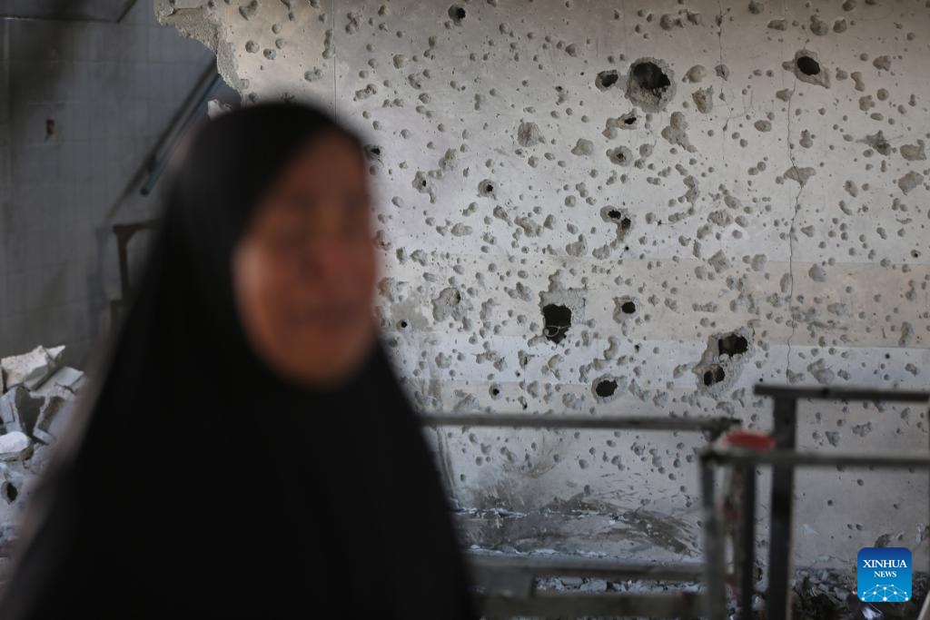 A Palestinian woman is seen at a school housing displaced persons in Nuseirat camp in the central Gaza Strip after an Israeli attack, on Oct. 14, 2024. At least 19 Palestinians were killed and dozens of others injured on Sunday in Israeli shelling on a school housing displaced persons in the Nuseirat refugee camp of central Gaza Strip, according to Palestinian sources. (Photo: Xinhua)