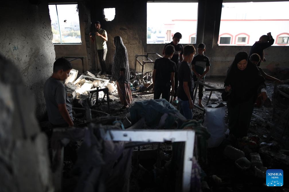 Palestinians are seen at a school housing displaced persons in Nuseirat camp in the central Gaza Strip after an Israeli attack, on Oct. 14, 2024. At least 19 Palestinians were killed and dozens of others injured on Sunday in Israeli shelling on a school housing displaced persons in the Nuseirat refugee camp of central Gaza Strip, according to Palestinian sources (Photo: Xinhua)