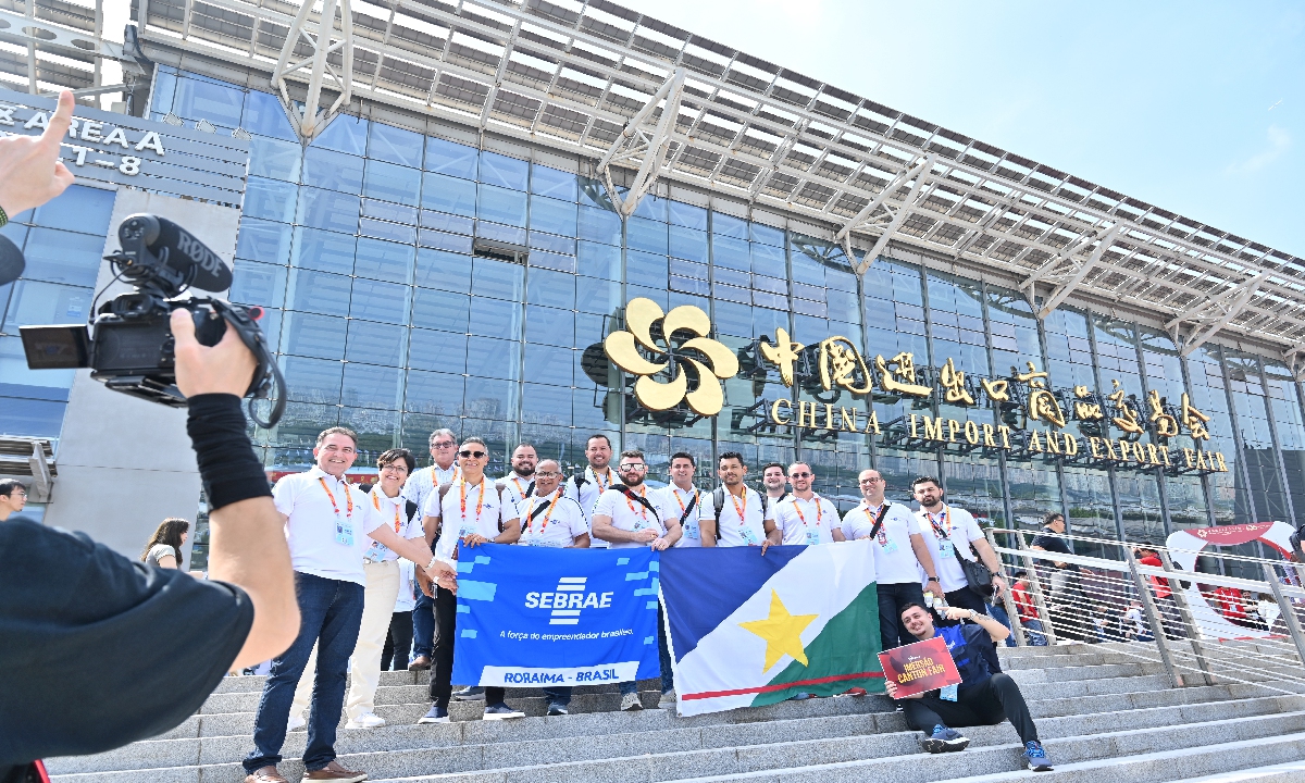 Brazilian buyers pose for a group photo in front of the venue of the 136th session of the China Import and Export Fair, commonly known as Canton Fair, on October 15, 2024. The Canton Fair will be held in three phases from October 15 to November 4. Photo: cnsphoto 