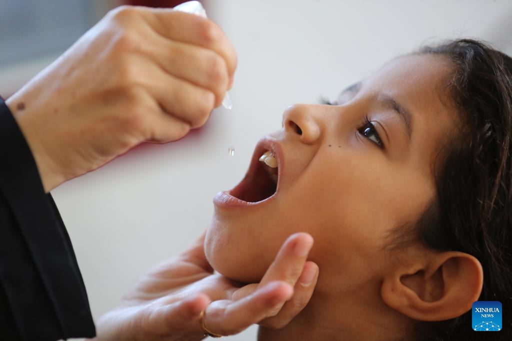 A child receives a dose of the polio vaccine at Al-Maghazi camp, central Gaza Strip, on Oct. 14, 2024. Gaza-based health authorities said on Saturday that the second round of the polio vaccination campaign in the central Gaza Strip is scheduled to start on Monday for three or four days. (Photo: Xinhua)