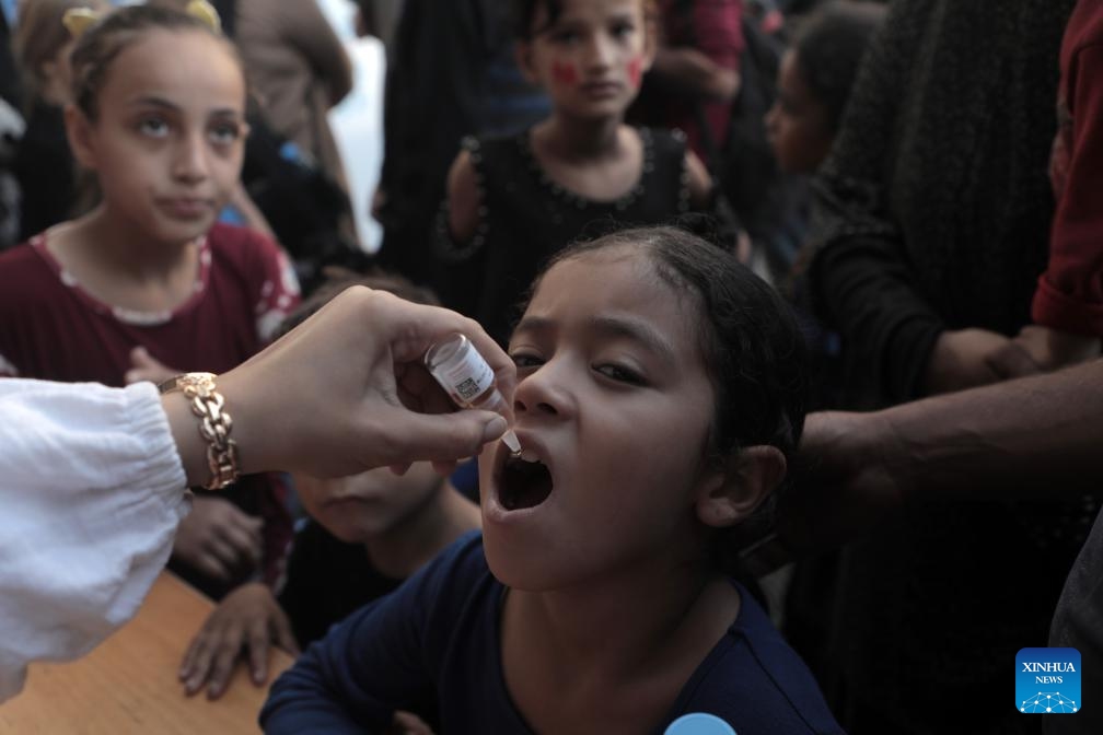 A child receives a dose of the polio vaccine at Al-Maghazi camp, central Gaza Strip, on Oct. 14, 2024. Gaza-based health authorities said on Saturday that the second round of the polio vaccination campaign in the central Gaza Strip is scheduled to start on Monday for three or four days. (Photo: Xinhua)