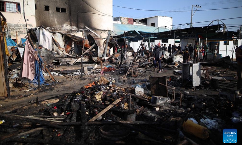 Palestinians inspect destroyed tents at Al-Aqsa Martyrs Hospital in Deir al-Balah in the central Gaza Strip after an Israeli attack, on Oct. 14, 2024. At least three Palestinians were killed on Monday in an Israeli airstrike that targeted the tents of displaced persons in Deir al-Balah, located in the central Gaza Strip, according to Palestinian sources. (Photo: Xinhua)