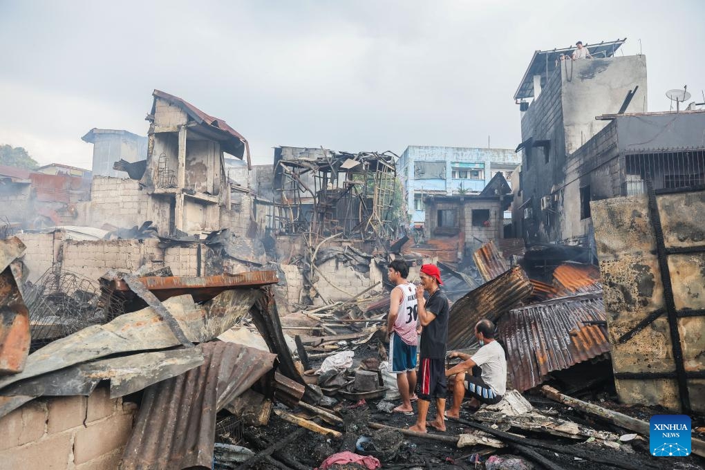 Residents return to their charred homes after a fire at a slum area in Manila, the Philippines, on Oct. 15, 2024. (Photo: Xinhua)