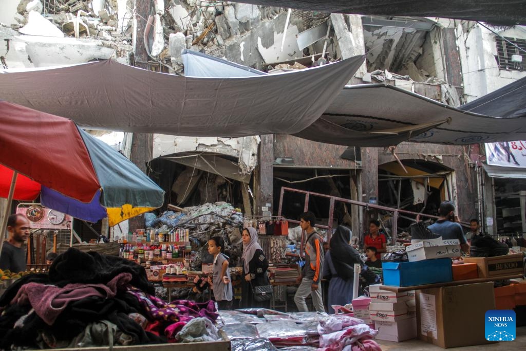 People walk through a market in Jabalia, northern Gaza Strip, on Oct. 15, 2024. (Photo: Xinhua)